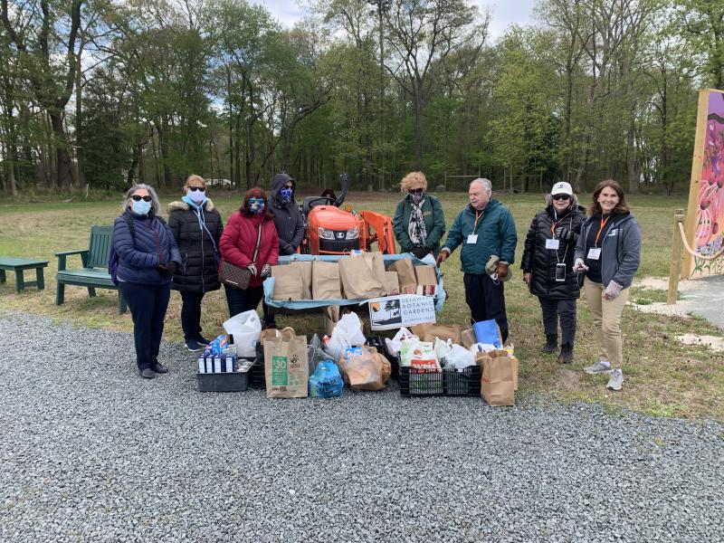 Delaware Botanic Gardens officials gathered at the food collection point thanking donors are at right (l-r) DBG President Ray Sander, Executive Director Sheryl Swed, and Vice President Carol McCloud.